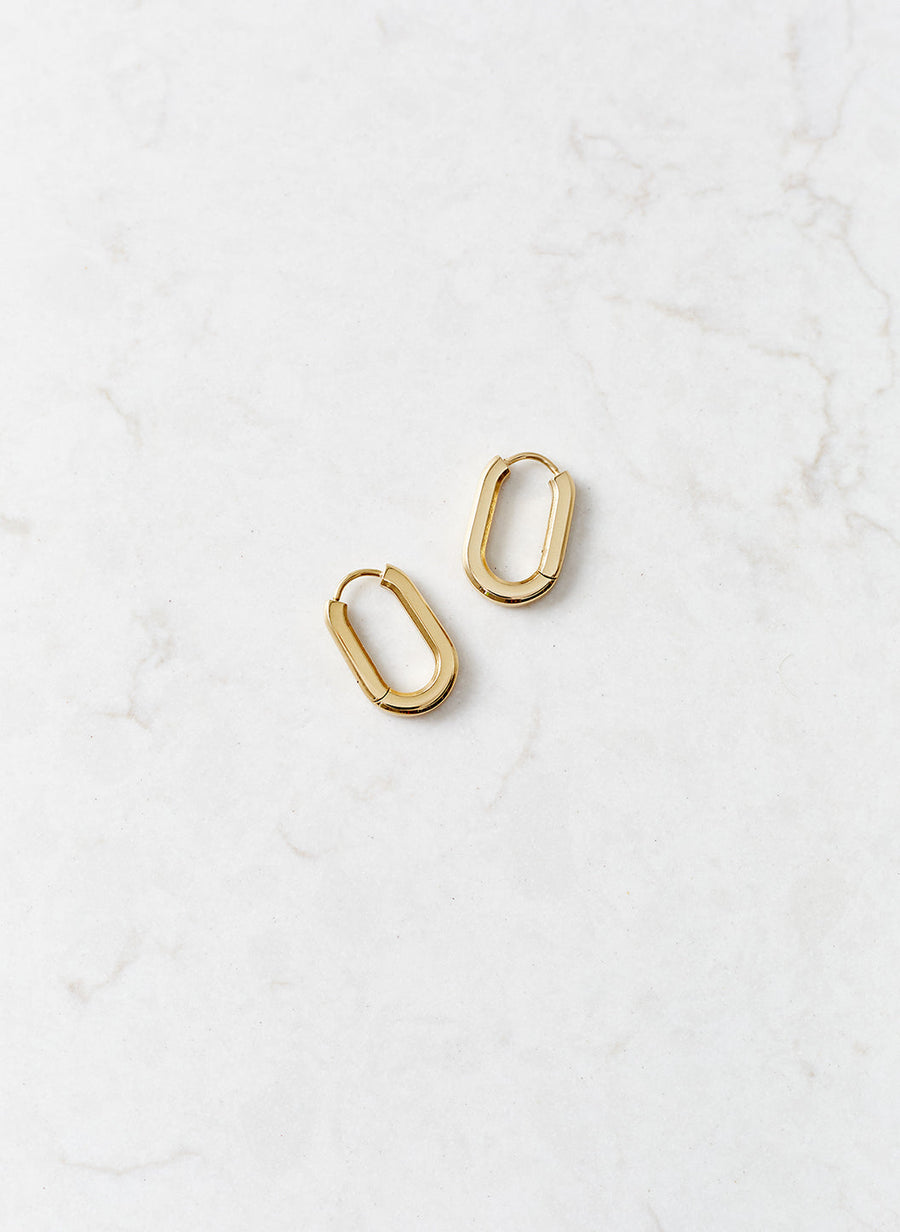 gold-oval-hoop-huggy-earrings_studio_image 